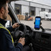 Chainway mobile scanner mounted on a delivery vehicle dashboard using an AgozTech cradle holder at a warehouse loading dock.