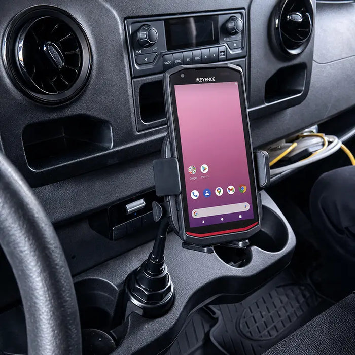 Keyence scanner secured in a cup holder vehicle cradle mount inside a commercial vehicle console.