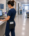 Nurse in a hospital setting using a computer with a tablet waist belt case attached to her waist.