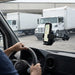Point Mobile handheld computer held in an AgozTech windshield vehicle cradle mount inside a delivery truck.