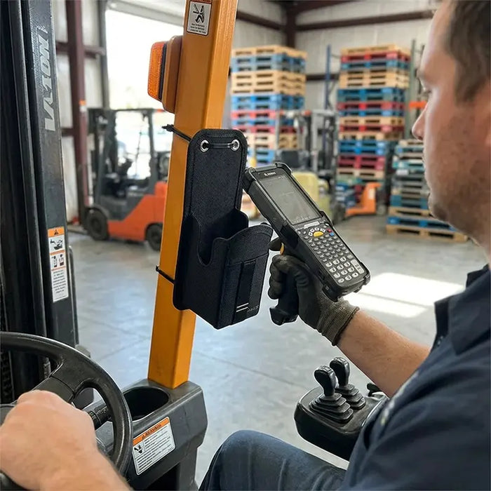 Forklift operator using Zebra MC9300 mobile computer next to AgozTech mounted holster holder
